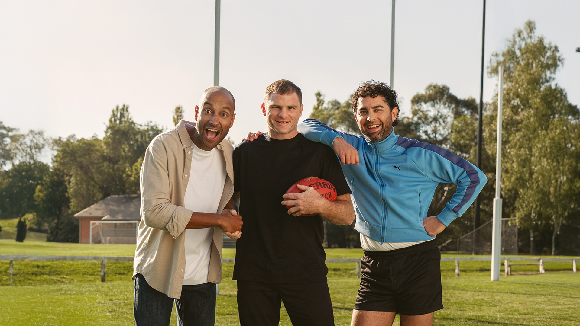AFL player smile at the camera together