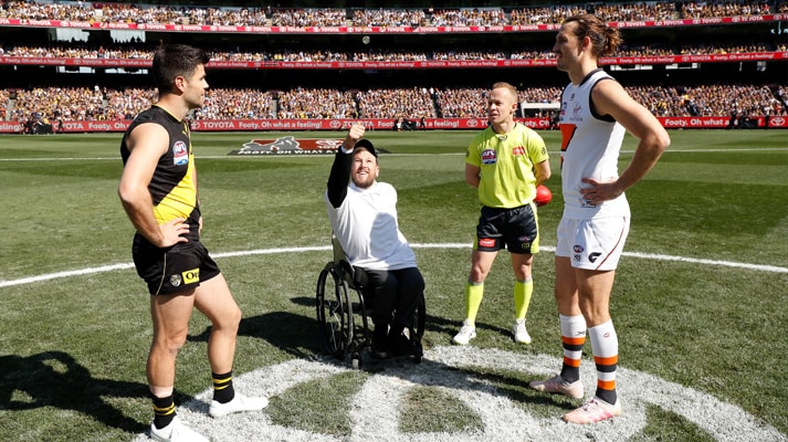 The coin flip being performed by Dylan Alcott at an AFL match between Richmond and GWS giants at the Melbourne Cricket Ground.