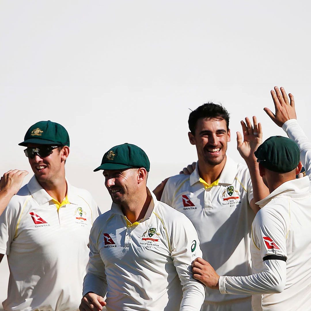 The Australian Men’s Cricket Team gathered together, clad in their cricket uniforms and iconic baggy green caps, congratulating each other on a job well done.