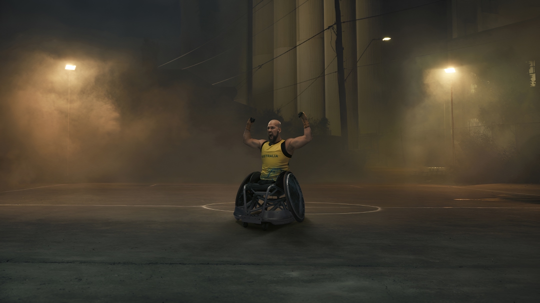 Australian Paralympian wheelchair rugby player Ryley Batt, posing with his arms flexed upwards, on a moodily lit, foggy basketball court at night.