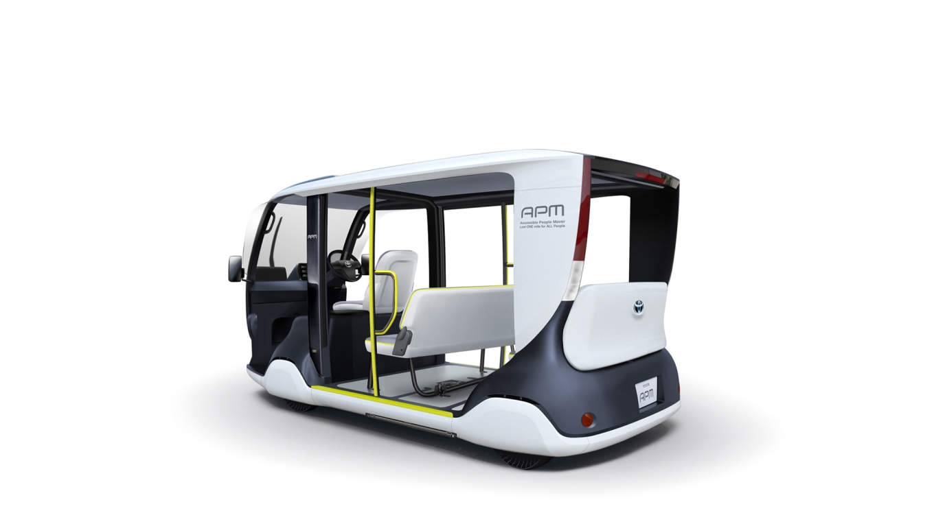 The APM, (Accessible People Mover), a mobility vehicle resembling a large white and grey golf buggy, designed to transport as many people as possible at once.