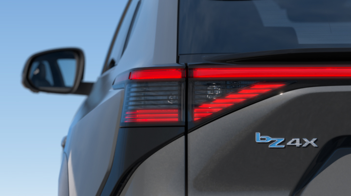 A close-up of the rear of a grey Toyota bZ4X. Featuring the bZ4X’s vehicle's taillight design, which features horizontal LED strips.