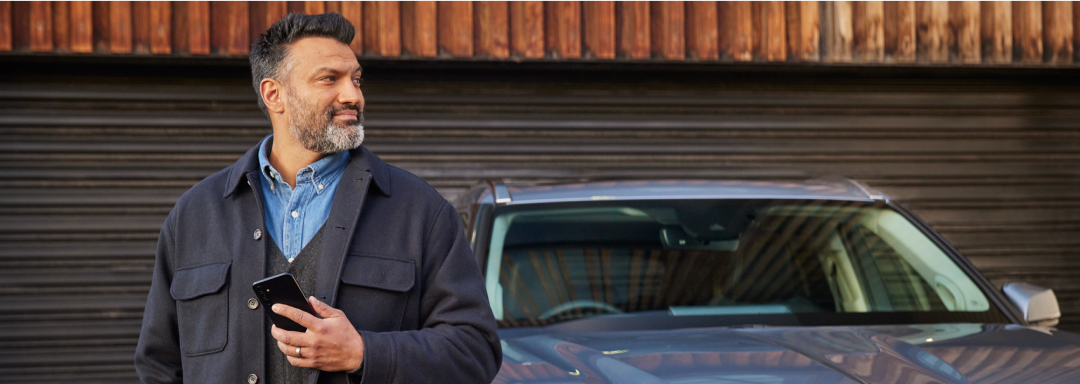 The rear center console of a Toyota, featuring a touchscreen display for climate and seat controls, and a leather armrest.