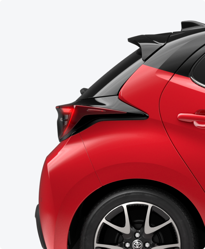 Rear bumper of a red Toyota Yaris.