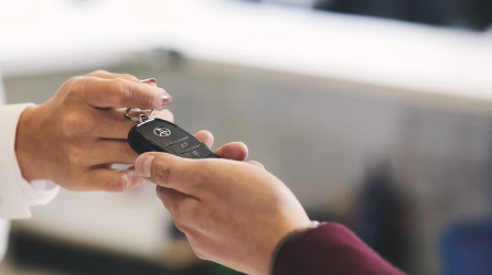 Dealer handing over keys to buyer