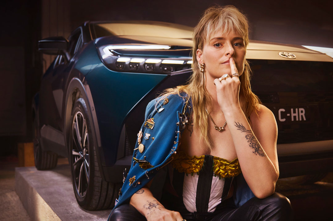 Millie Savage sitting in front of C-HR